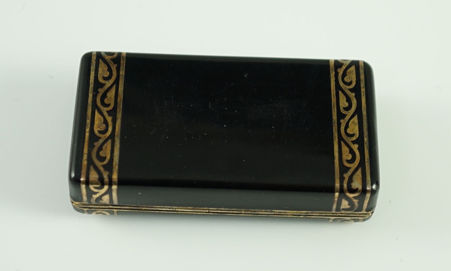 A late 1920's French Cartier silver gilt, black enamel and diamond set snuff box, in fitted gilt tooled leather Cartier box